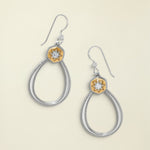 Pair of silver and gold hoop earrings on a white background