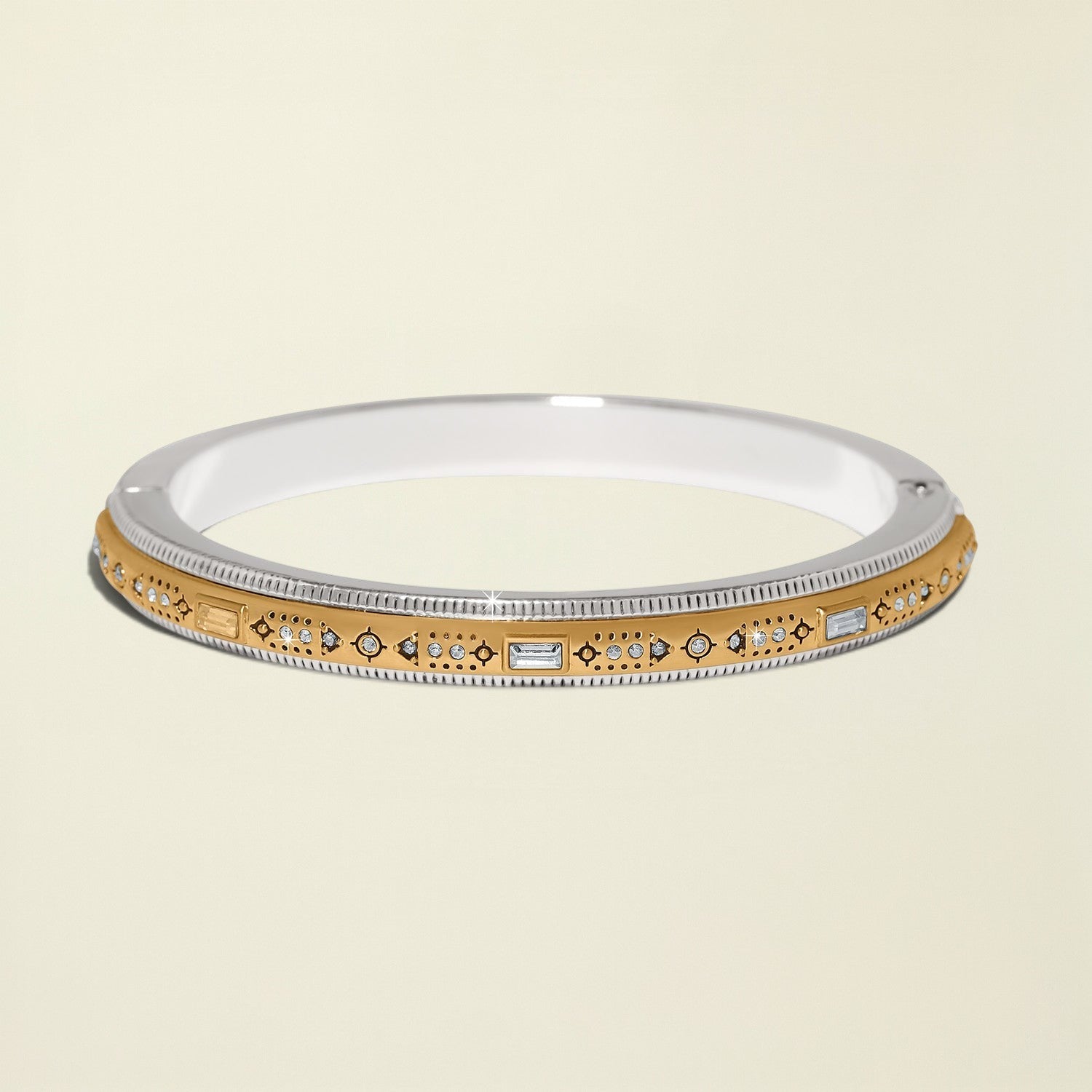 Gold and silver bracelet with gemstones on a white background