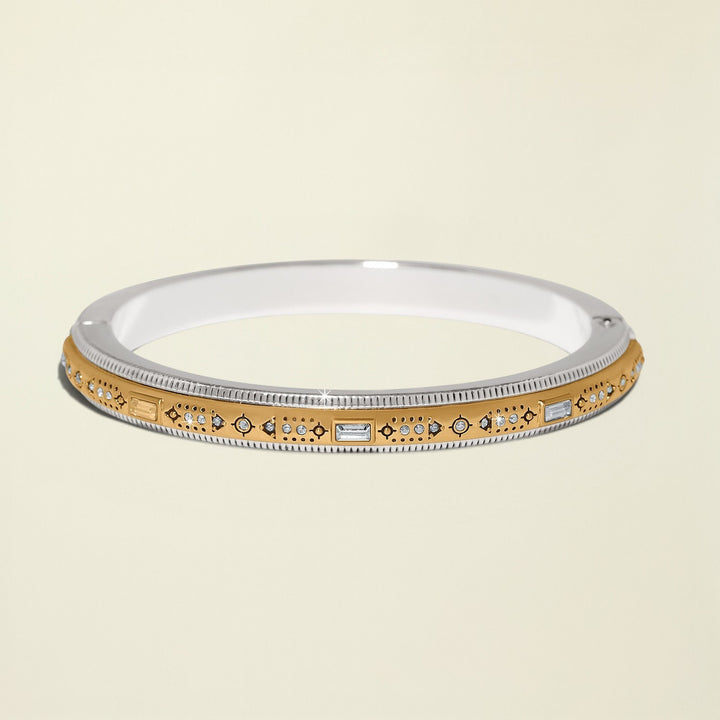 Gold and silver bracelet with gemstones on a white background