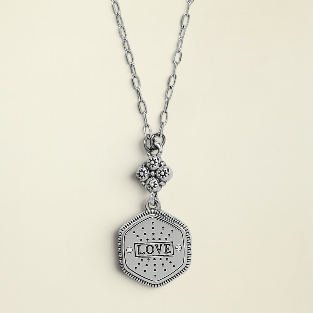 Silver necklace with a 'LOVE' pendant on a white background