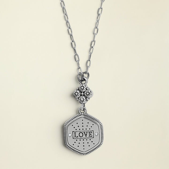 Silver necklace with a 'LOVE' pendant on a white background
