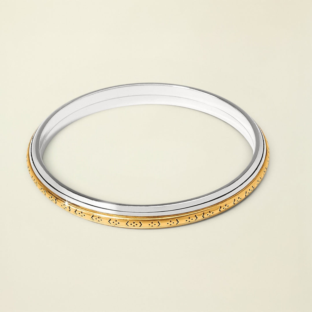 Gold and silver bangle on a white background
