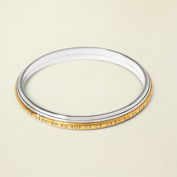 Gold and silver bangle on a white background