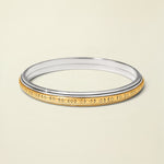 Two-tone ring with gold and silver design on a white background
