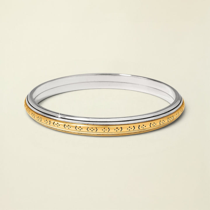 Two-tone ring with gold and silver design on a white background