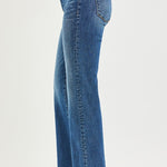 Blue jeans worn by a person on a white background