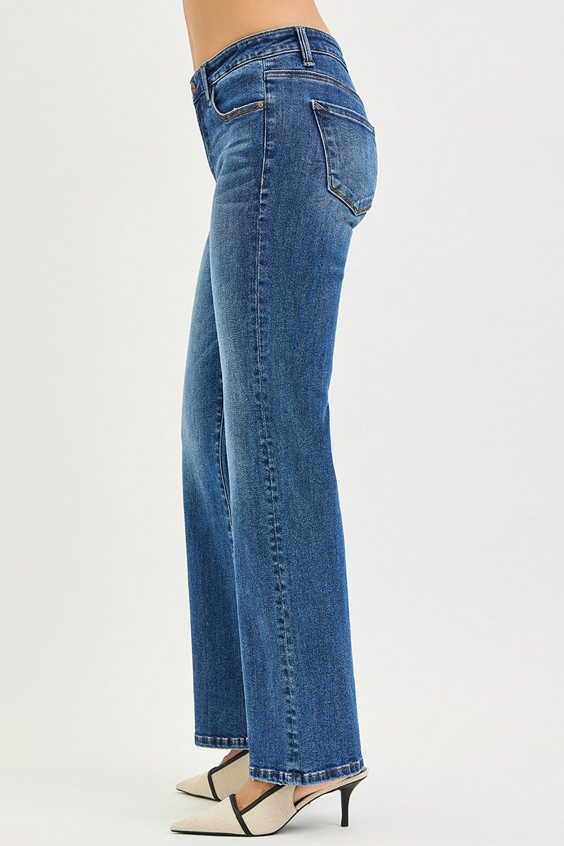 Blue jeans worn by a person on a white background