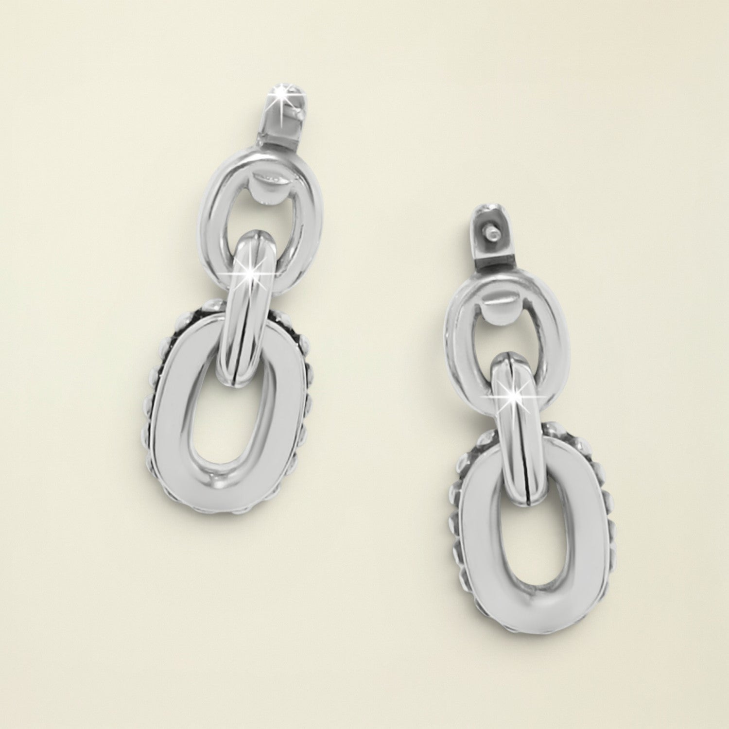 Pair of silver chain-link earrings on a white background