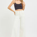 woman wearing black tank and Risen Cream Wide Leg Jeans