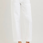 Person wearing white pants on a plain background