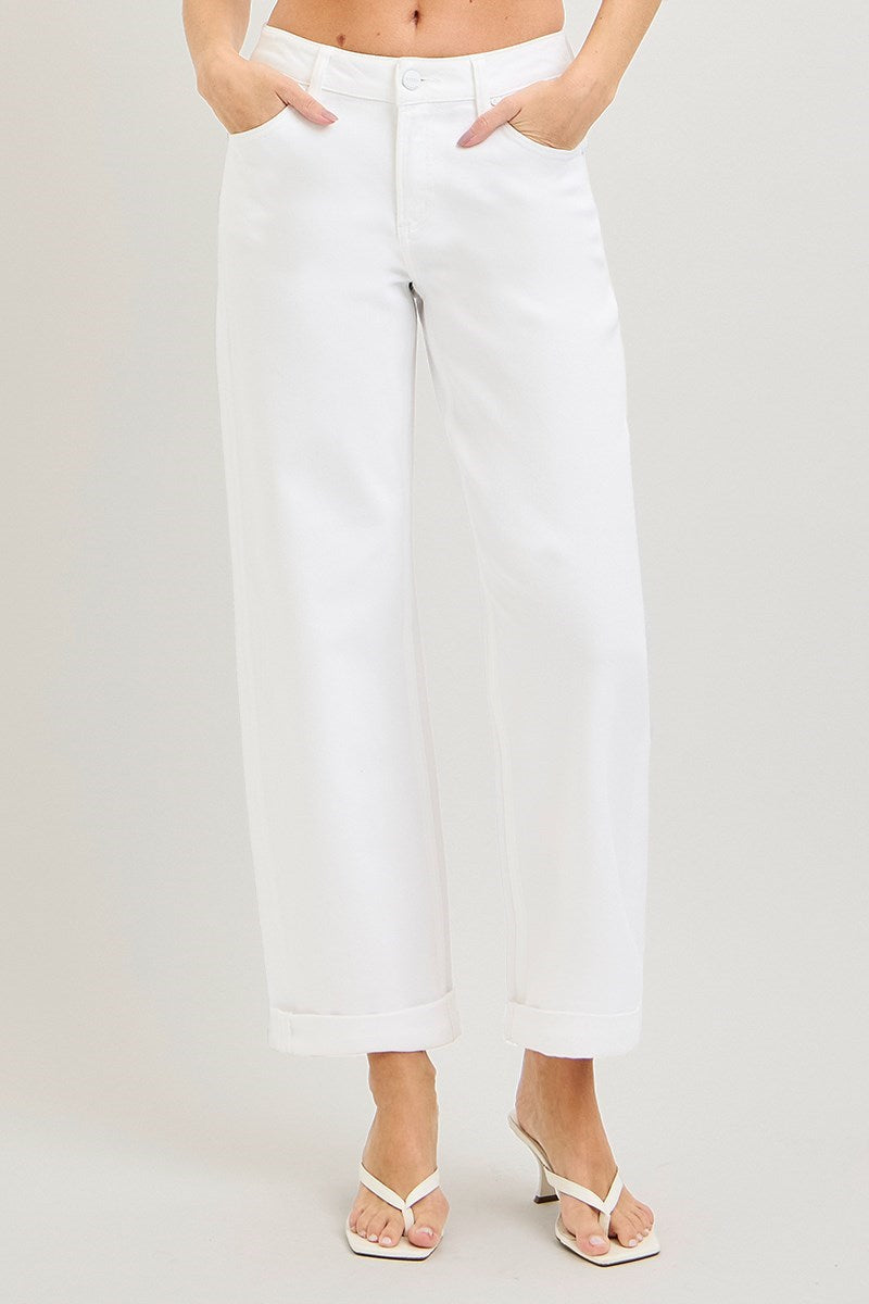Person wearing white pants on a plain background