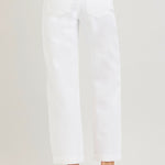 White pants worn by a person on a white background