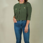 Woman wearing olive ribbed flap pocket cardigan with jeans