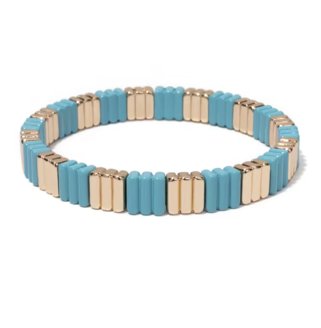 A stretch bracelet with gold plated accents and blue enamel tiles.