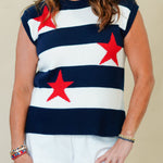 Woman wearing a navy blue sleeveless top with red star patterns and white shorts on a beige background