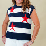 Woman wearing a sleeveless top with red star patterns and white shorts on a beige background
