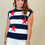 Woman wearing a striped shirt with red stars and white shorts on a plain background