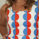 close up of women wearing red and blue geo print tank 