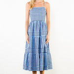 Woman wearing a blue and white striped dress on a white background
