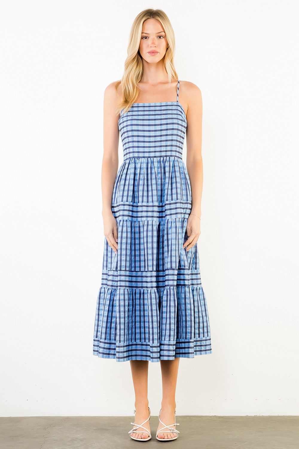 Woman wearing a blue and white striped dress on a white background