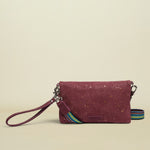 Maroon cork wallet with a colorful strap on a white background