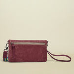 Maroon handbag with a strap on a white background
