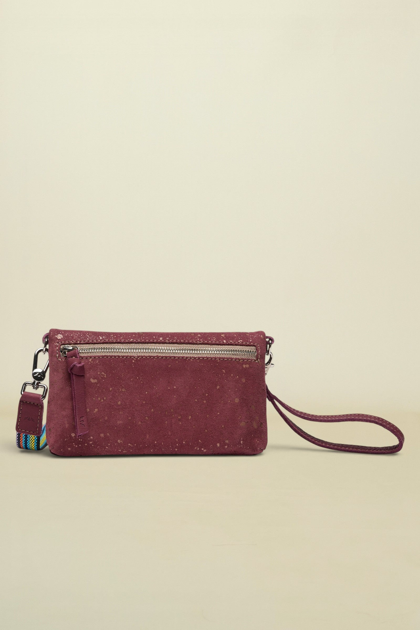 Maroon handbag with a strap on a white background