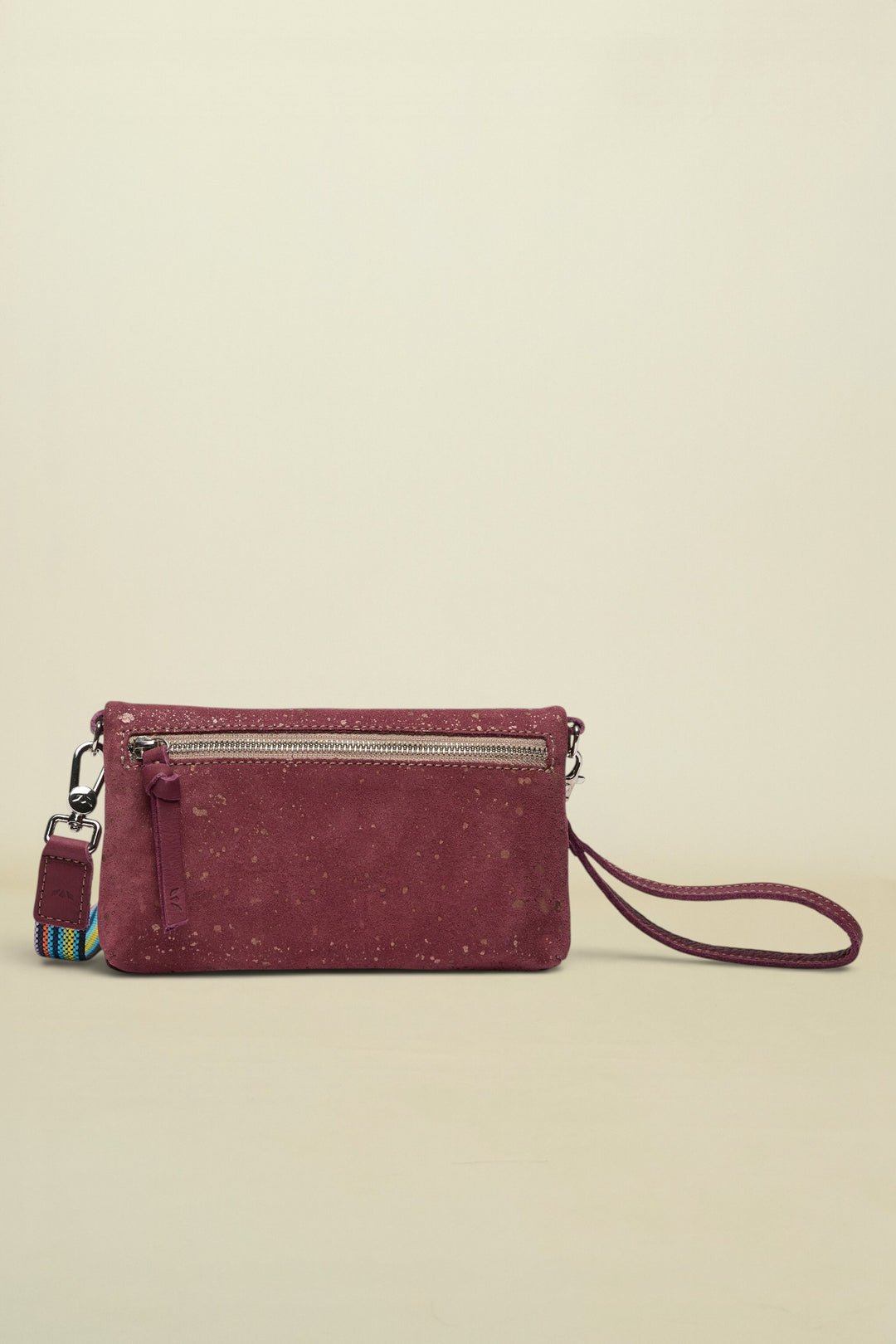 Maroon handbag with a strap on a white background