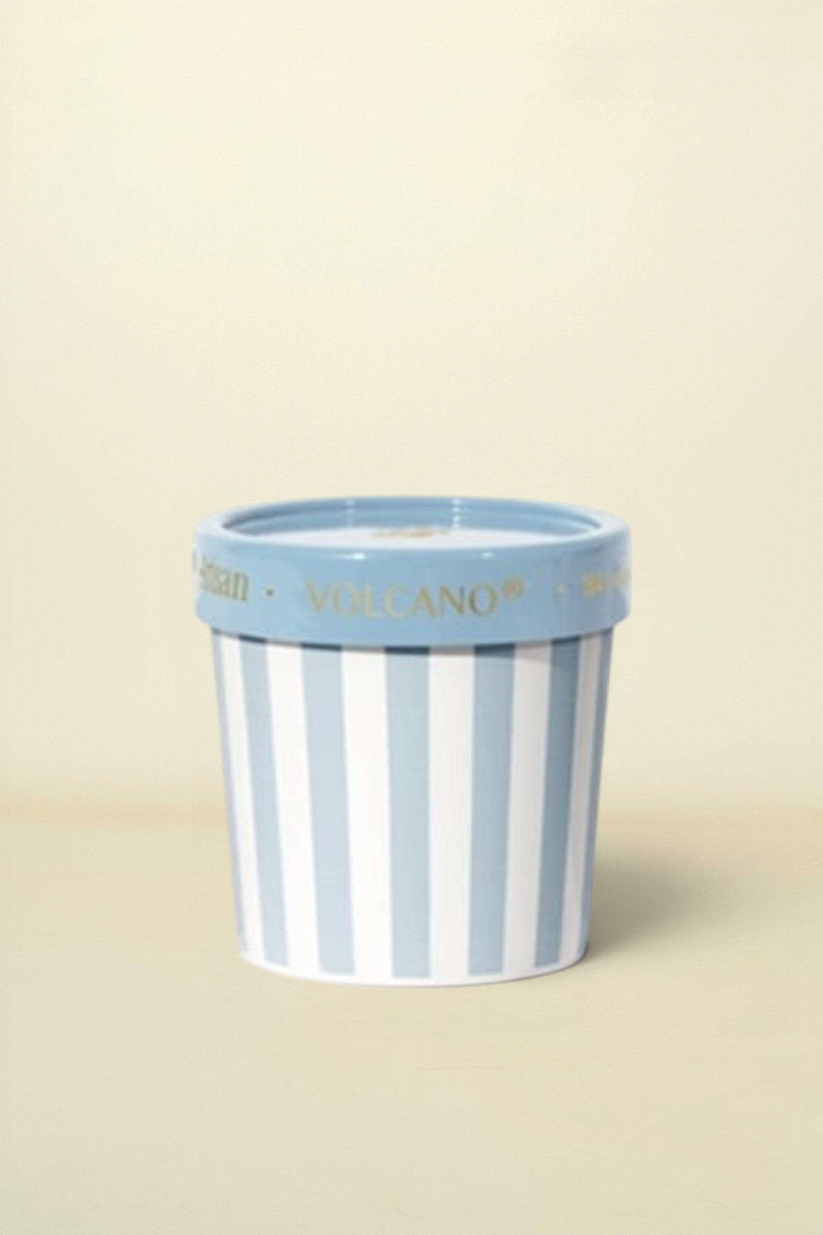 Striped ceramic pot with blue rim on a white background