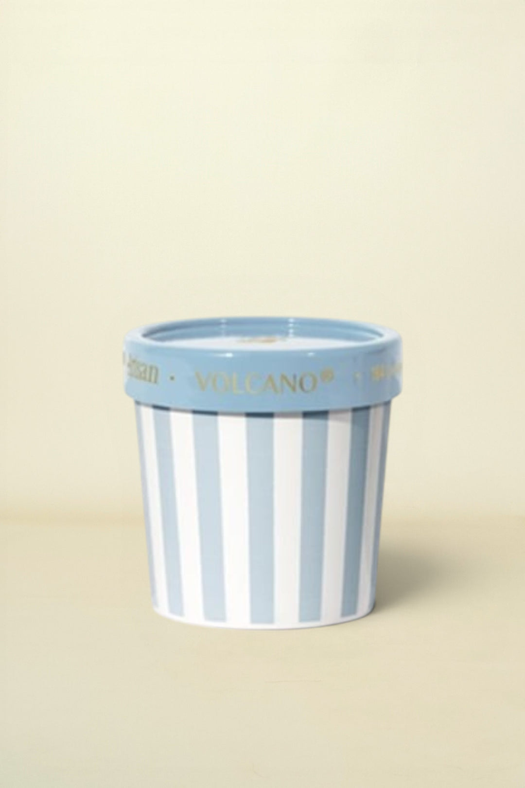 Striped ceramic pot with blue rim on a white background