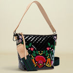 Colorful handbag with floral embroidery on a white background