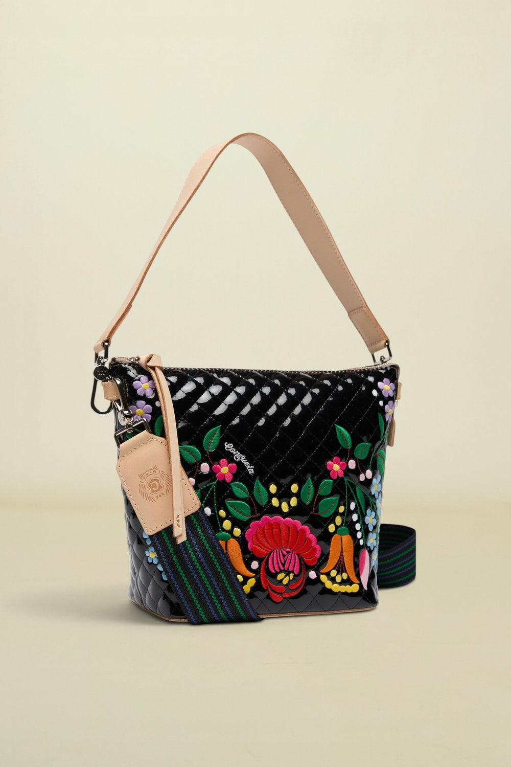 Colorful handbag with floral embroidery on a white background