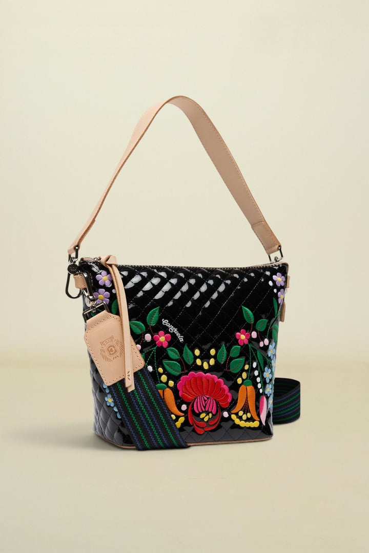 Colorful handbag with floral embroidery on a white background