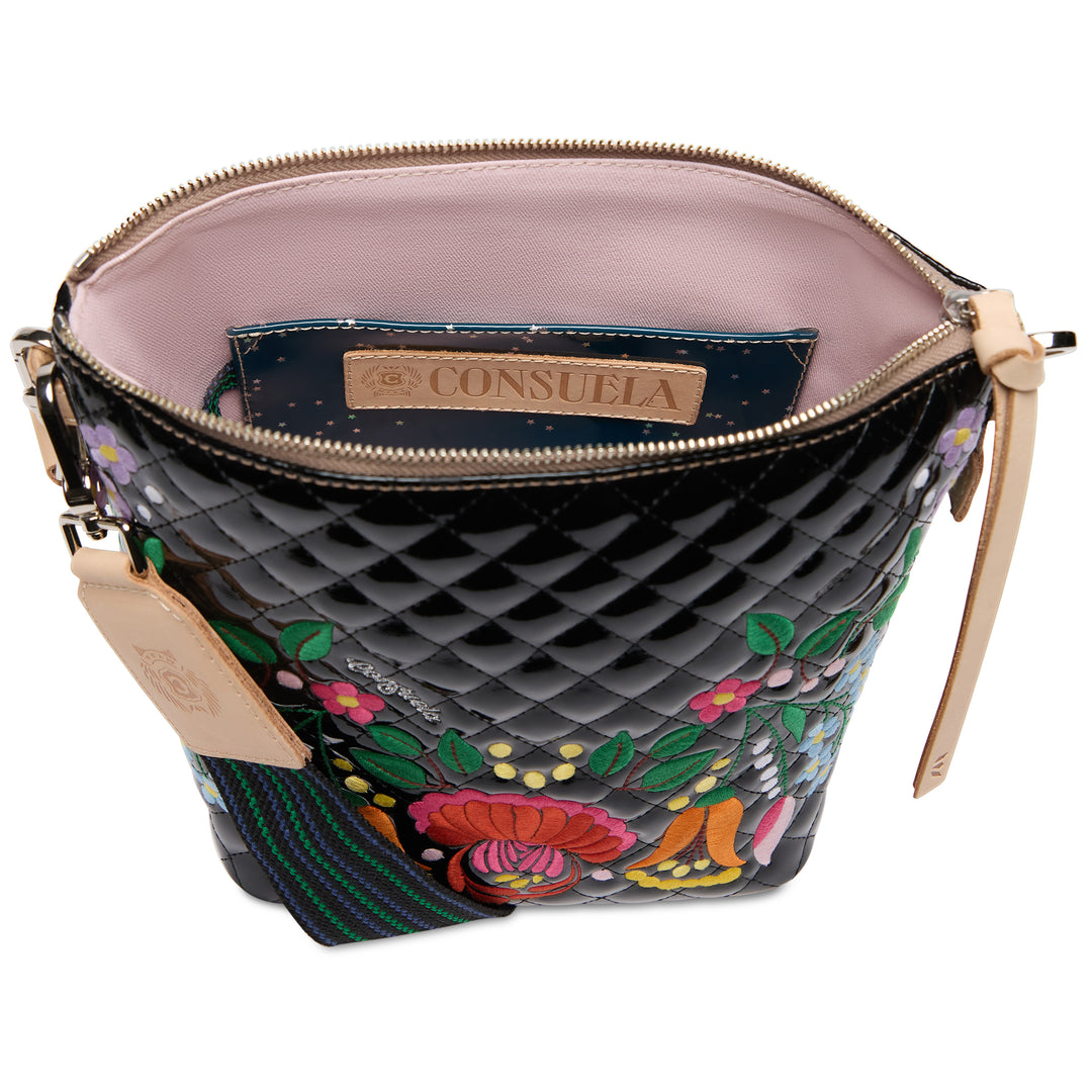 Quilted handbag with floral embroidery and visible brand logo on a white background