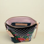 Quilted handbag with floral embroidery and visible brand logo on a white background