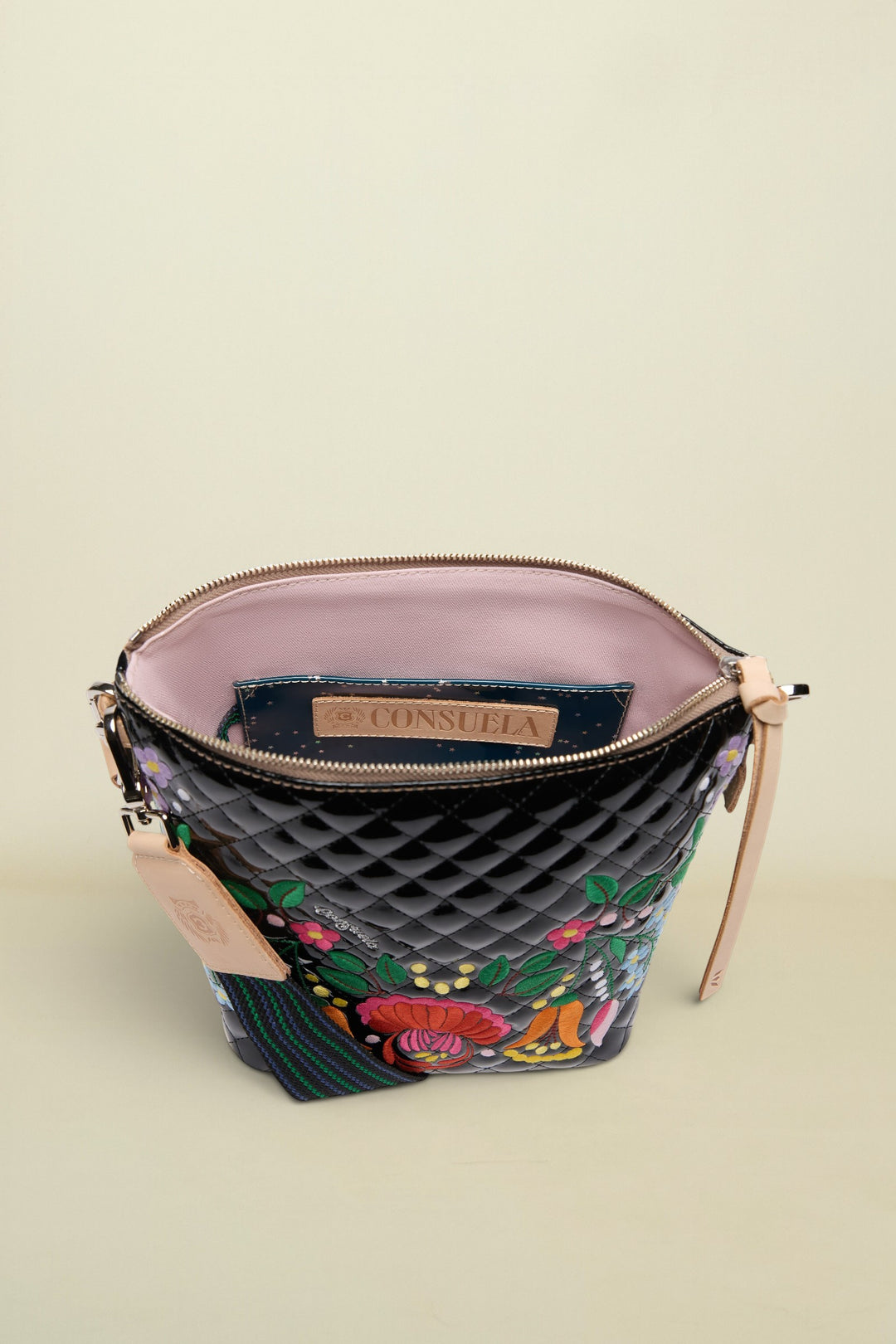 Quilted handbag with floral embroidery and visible brand logo on a white background