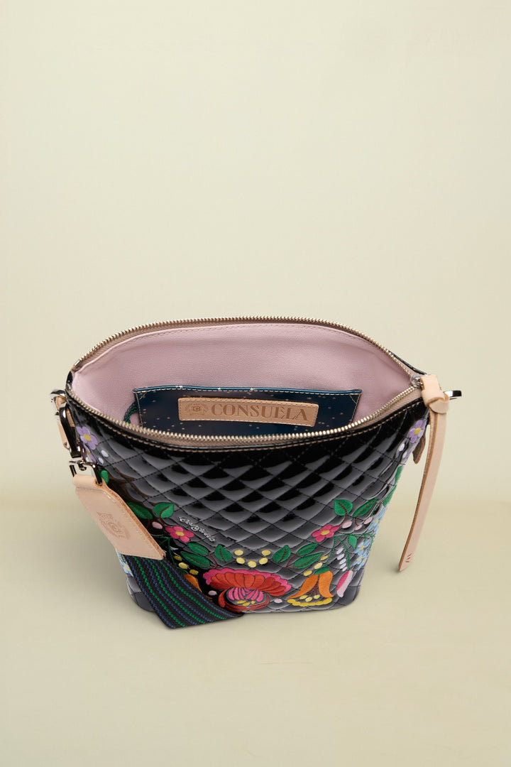 Quilted handbag with floral embroidery and visible brand logo on a white background