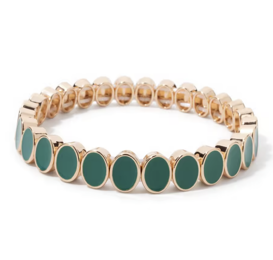 Bracelet with gold and green beads on a white background