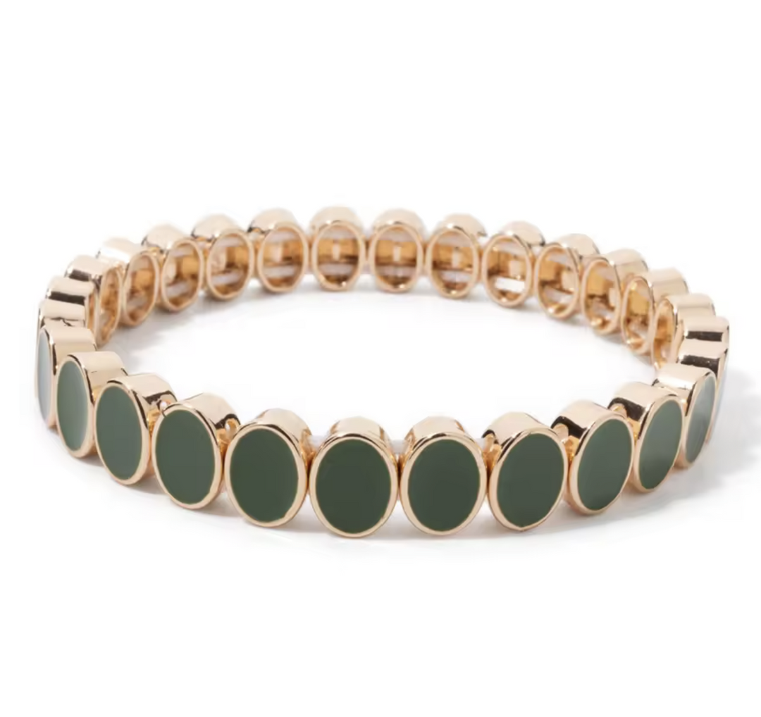 Bracelet with gold and green beads on a white background