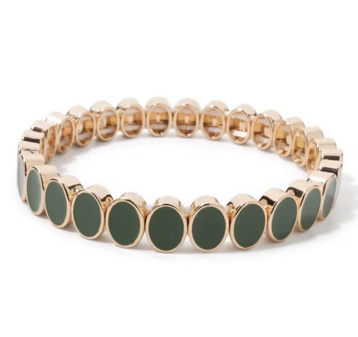 Bracelet with gold and green beads on a white background