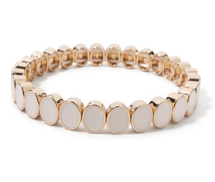 Bracelet with gold and white circular beads on a white background