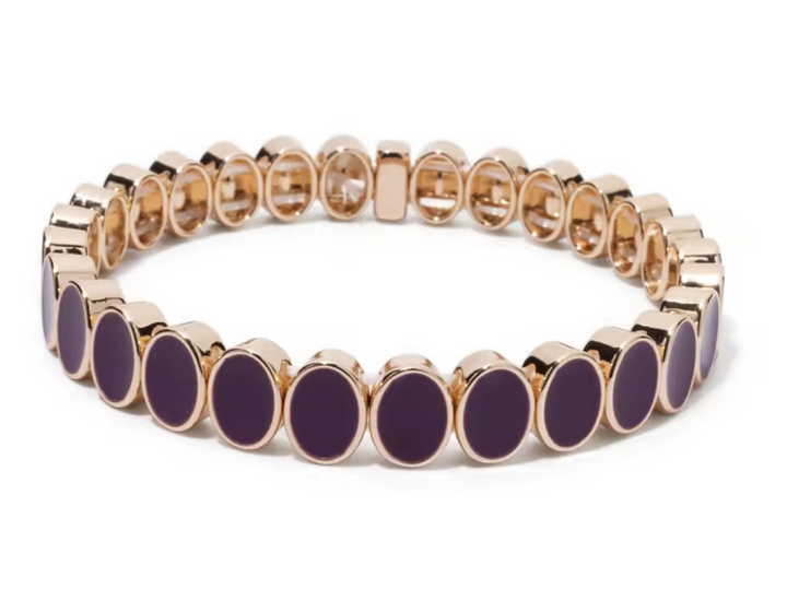 Bracelet with purple beads and gold accents on a white background