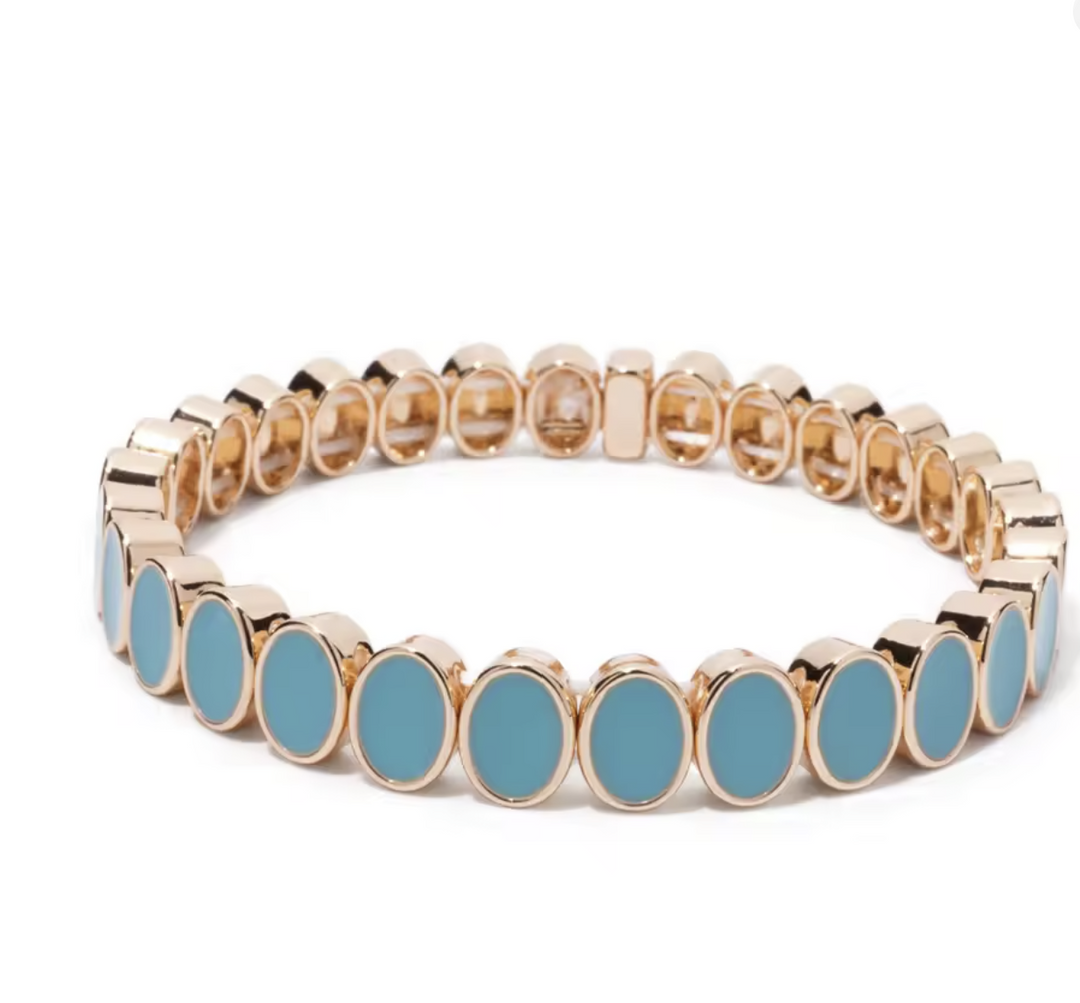 Bracelet with gold and blue circular beads on a white background