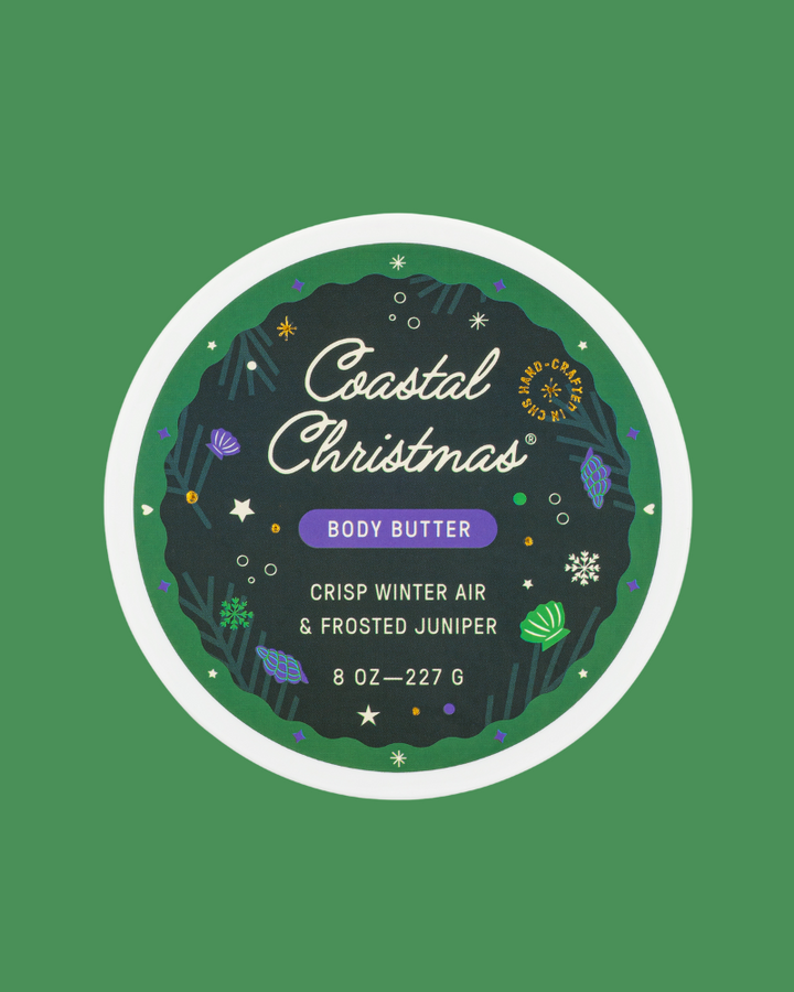 Coastal Christmas body butter container with decorative label on a green background