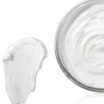 Jar of white cream with a swatch on a white background
