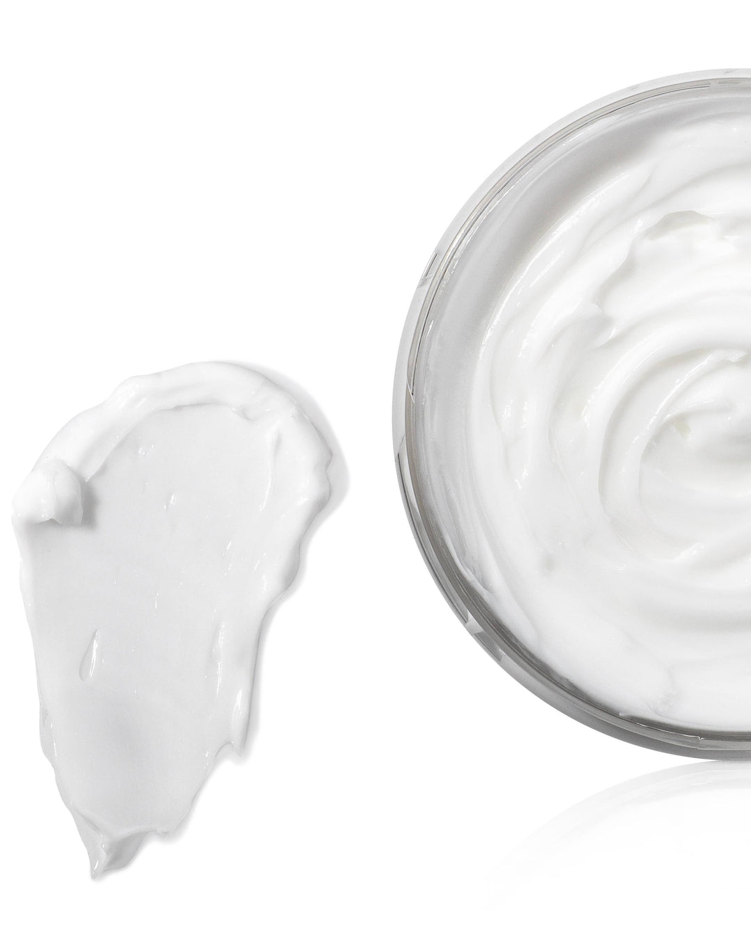 Jar of white cream with a swatch on a white background