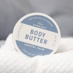 Body butter container with a label on a textured surface