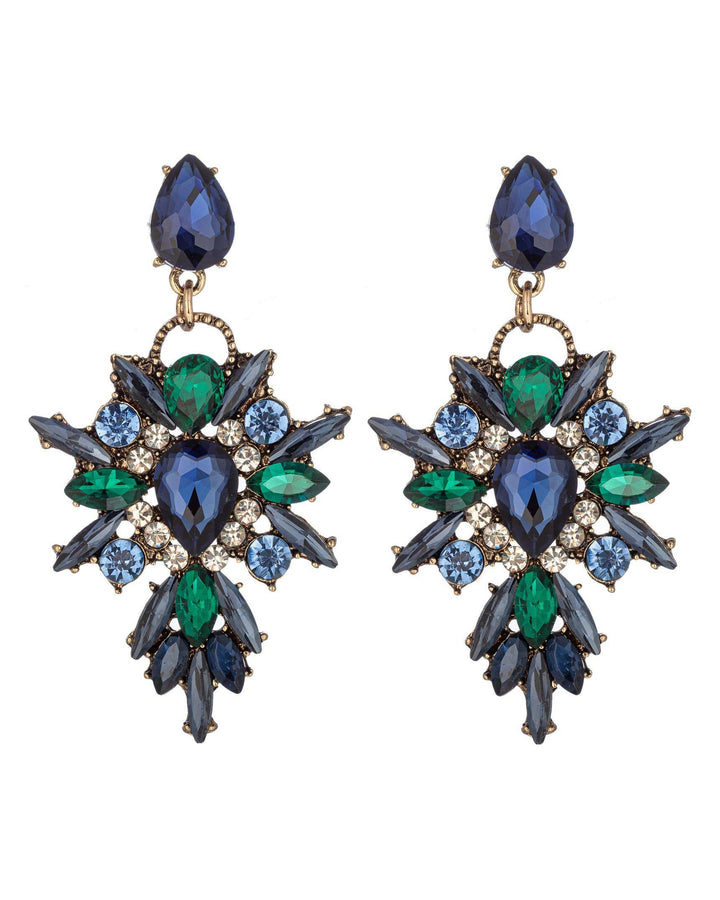 Pair of ornate earrings with blue and green gemstones on a white background