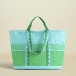 Green and blue tote bag on a beige background