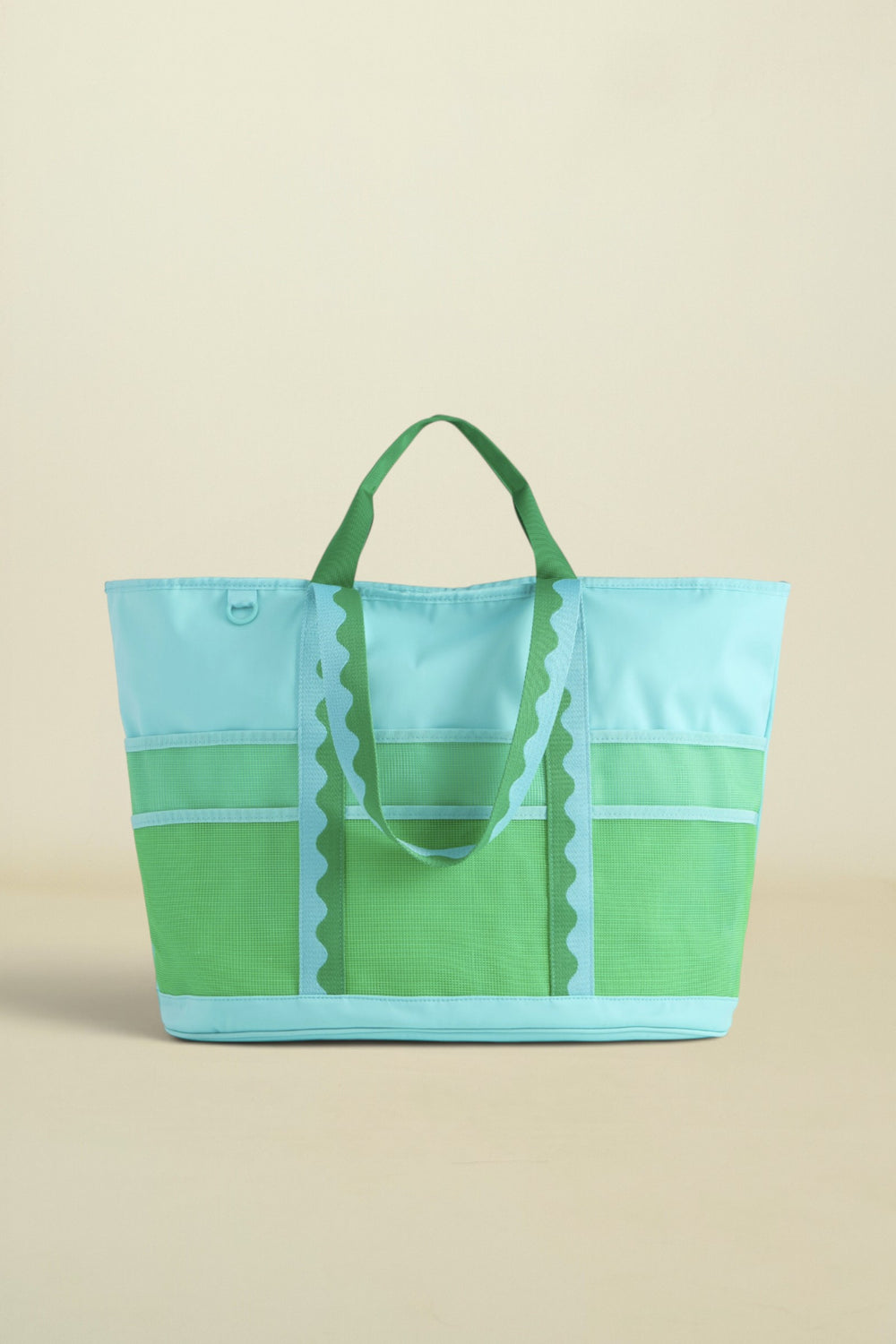 Green and blue tote bag on a beige background
